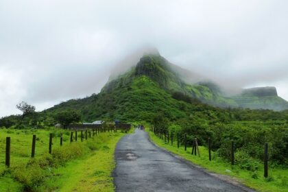 An image of Visapur Fort trekking showing rugged paths with lush greenery and scenic views