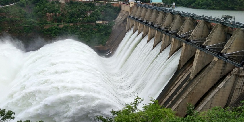 Vishnupuri Dam releasing water, creating strong currents and mist over the river.