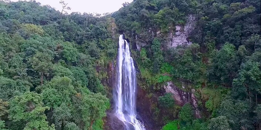 Things to do in Chikmagalur include a visit to Hebbe Falls surrounded by lush green landscapes.