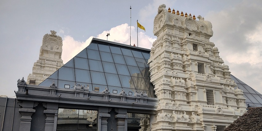Beautiful white marble ISKCON temple in Amravati with devotional devotees in the courtyard