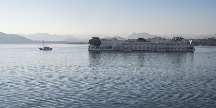 An image showing the stunning Taj Lake Palace from the City Palace, a must-see in Udaipur's landscape.