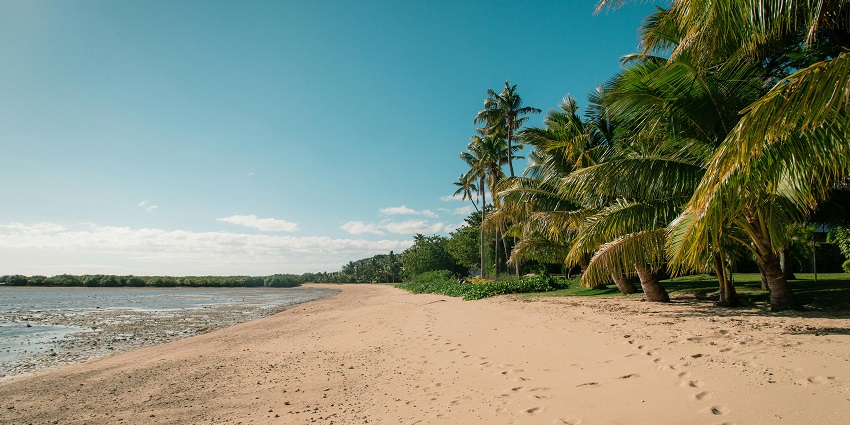 Empty beach with soft waves and cloudy sky at a Beach, seen from the shoreline