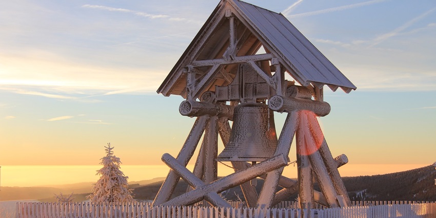 An image showing the Peace Bell present in the mosque surrounded by scenic views.