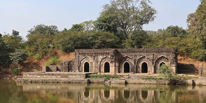 Sacred Moksha Kund near Bhimashankar Temple, surrounded by serene greenery and spiritual ambiance.