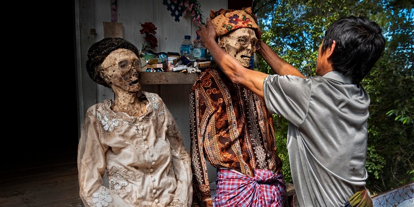 A tradition of changing the corpse clothes in Tana Toraja Highlands in Indonesia, one of the things to do in Indonesia.