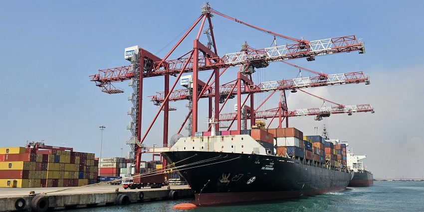 A picture of the Tuticorin Port, featuring large cargo ships and trading activities.