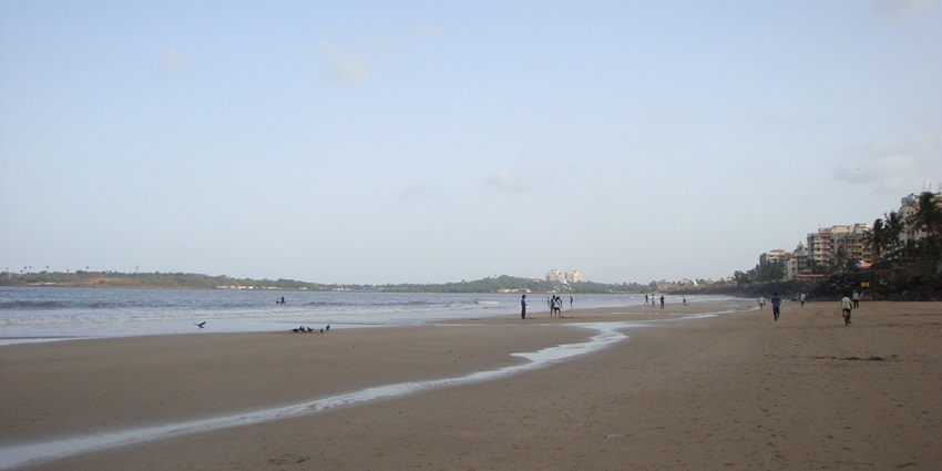 Versova Beach in Mumbai, featuring a tranquil sandy shoreline with gentle wave