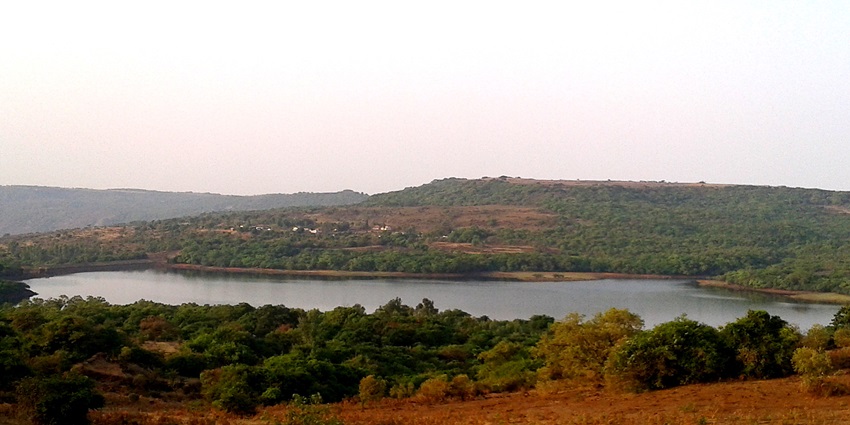 Kaas Lake reflecting clear skies, surrounded by lush greenery in Satara, Maharashtra.