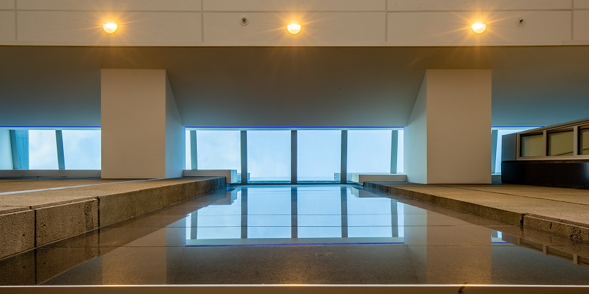 An art gallery with big open areas and window letting in light.
