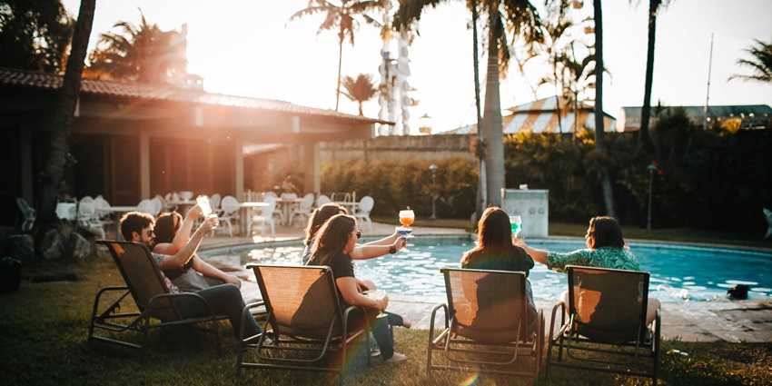 People enjoying their food and drinks at a pool party - one of the party places in Singapore