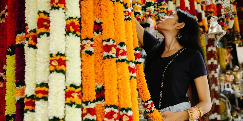 Woman admires textile decorations in a charming Basavan Bagewadi shop, a must-see among things to do in Vijayapura.