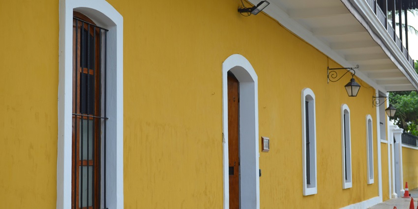 An image of a yellow building with large windows in the French Quarter in Karaikal.