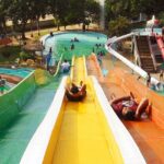 Image of families enjoying thrilling slides at a water park in Uttar Pradesh