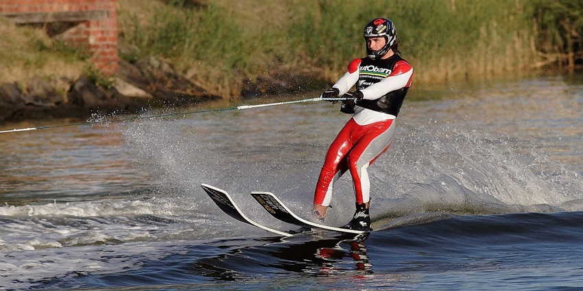 Exhilarating water skiing activity, gliding on water while being pulled by a fast-moving boat.
