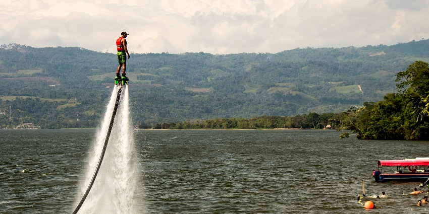 Image of a man flyboarding - water sports at the beach, an adventurous thing to do in goa in april