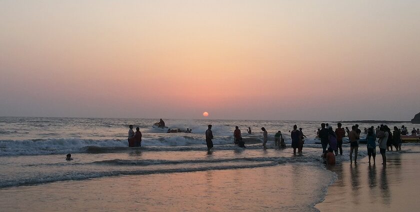 Sunset over Alibaug Beach, with vibrant colors reflecting on the calm water.