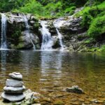 A glimpse of a beautiful waterfall featuring greenery and serene waters in Maharashtra.