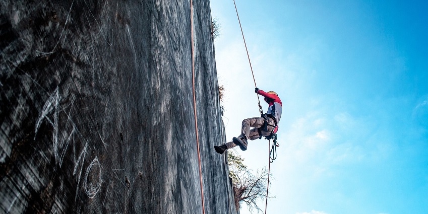 A picture of adventurers rappelling down a powerful waterfall in Maharashtra’s rugged terrain.