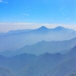 A beautiful view of Kodaikanal featuring abundant greenery and a vast, calm lake