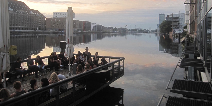 Party in Berlin at the popular riverside club featuring electronic music and stunning views.