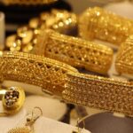 A glimpse of gold jewellery including bangles and necklaces presented at a store.