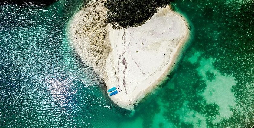 A bird’s eye view of turquoise-blue waters meeting the pristine golden sands in Indonesia.