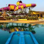 Aerial view of Wet N Joy Water Park Lonavala, featuring water slides and pools.