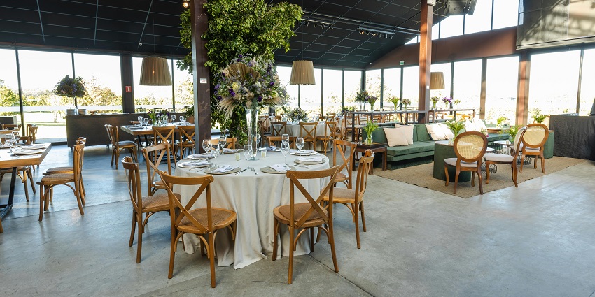 A view of a vibrant rooftop celebration featuring skyline views and beautiful decor.