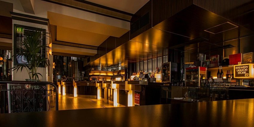 An empty Coffee shop filled with colourful lights, creating a vibrant and inviting atmosphere.