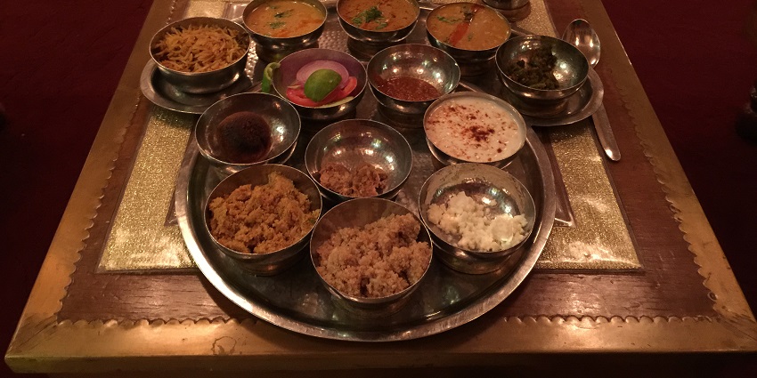 A Rajasthani thali showcasing the famous dal bati churma along with other dishes