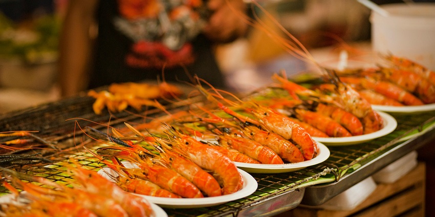 A plate of prawns with fresh ingredients, ready for a meal at Grand Inna Bali Beach Sanur