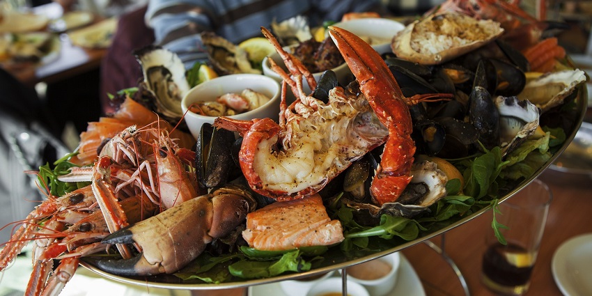 A scrumptious plate of food with vibrant seafood displayed on a platter.
