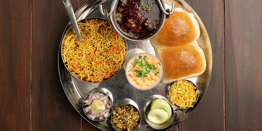 Local cuisine available near Vardhangad Fort like Misal Pav for travellers to try.