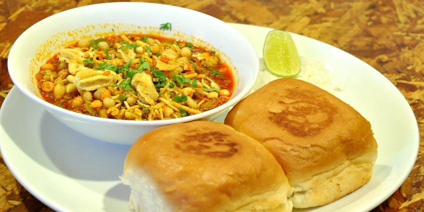 Image of delicious and authentic Maharashtrian cuisine Misal Pav served on a white plate