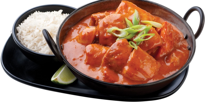 An image of freshly prepared Butter Chicken with rice in a nearby hotel in Haryana.
