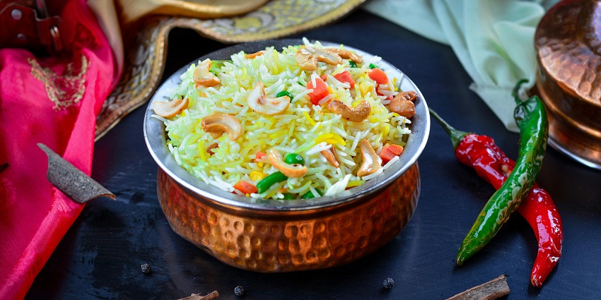 Snapshot of the rice mixed with various vegetable served in the bowl made of bronze
