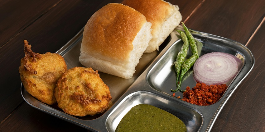 An image representing Vada Pav, a famous Maharashtrian dish available near it.