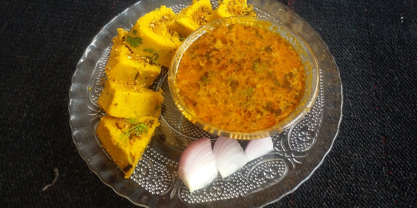 A bowl of traditional Maharashtrian Masswadi Rassa with spices and herbs.