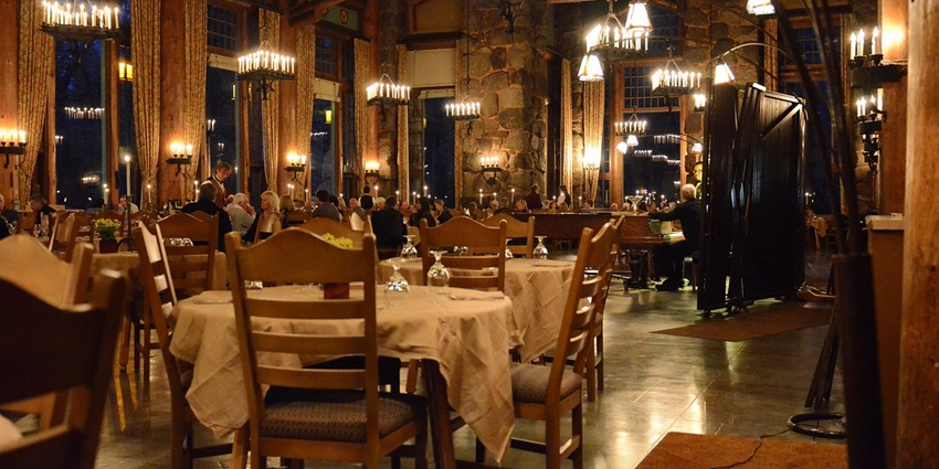 Stylish restaurant with neatly arranged dinner tables, creating a warm and inviting ambience.