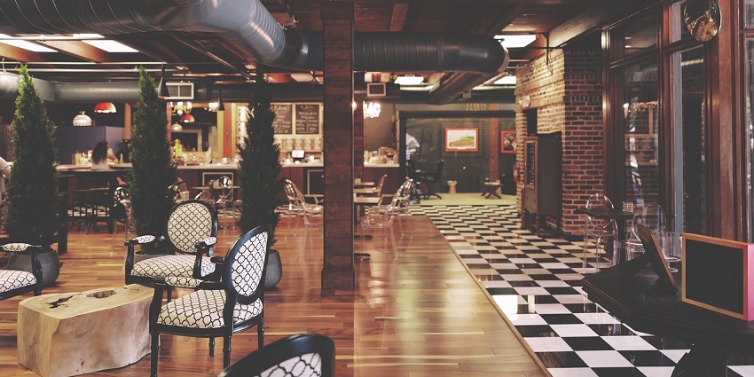 A view of the restaurant with furniture surrounded by trees near Mohini Water Park.