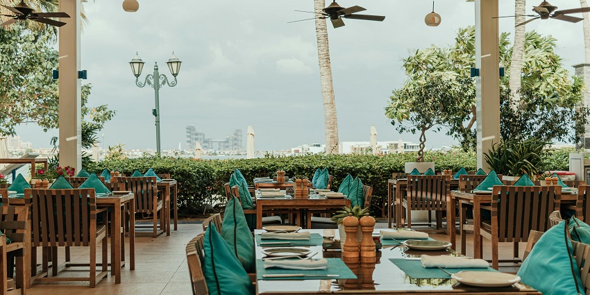n image of a local restaurant serving fresh seafood dishes with a beach view