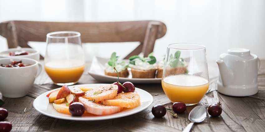 Delicious breakfast spread featuring a refreshing drink and appetising dishes.