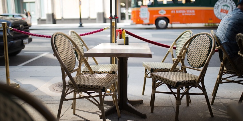 Bistro-style cafe with outdoor tables and chairs set up for dining and relaxation.