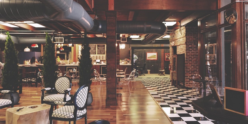 Stylish restaurant interior featuring modern furniture with tables and comfortable seating.