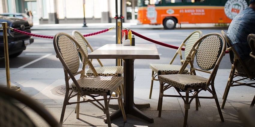 Charming café with outdoor tables and chairs, inviting guests to relax and enjoy.