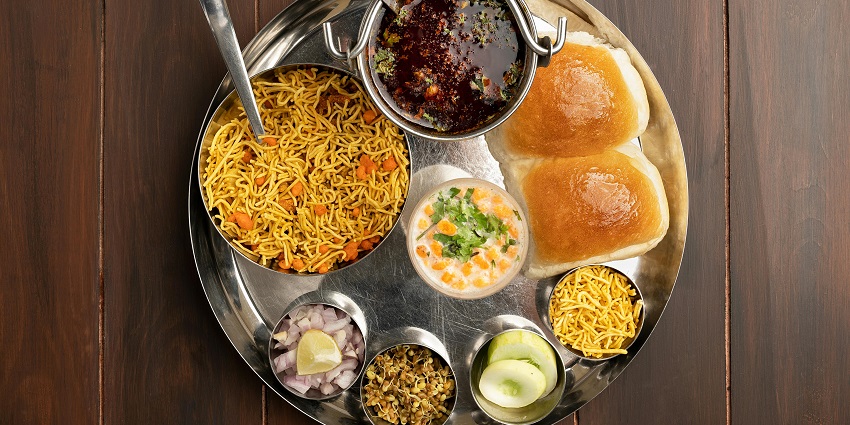 Delicious Rajasthani food served near Narayangad Fort's scenic views.