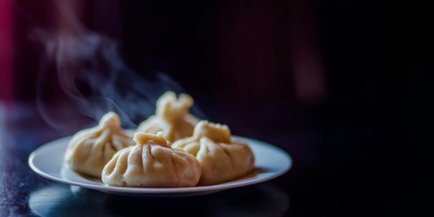 Delicious dim sum served on a ceramic plate, showcasing vibrant colors and textures.