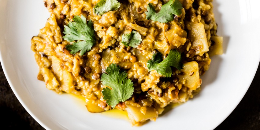 A mouth-watering view of a plate served with a cooked dish and garnished with coriander.