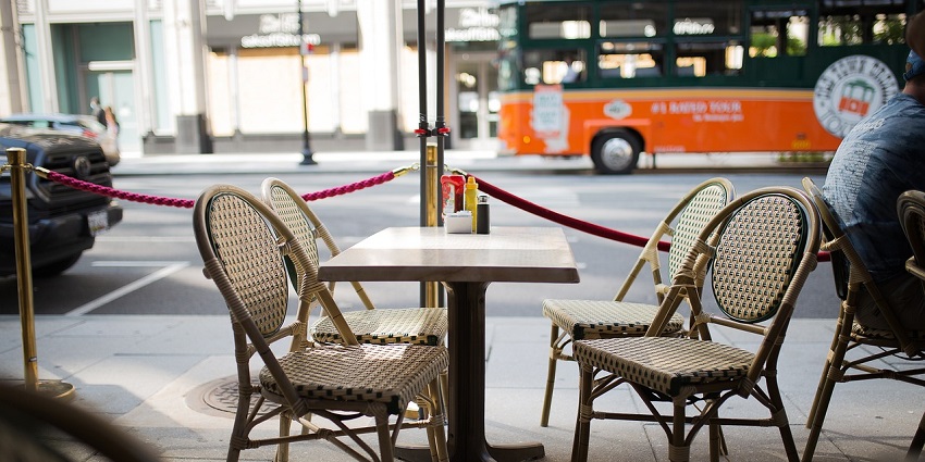 Charming café with outdoor tables and chairs, inviting guests to relax and enjoy.