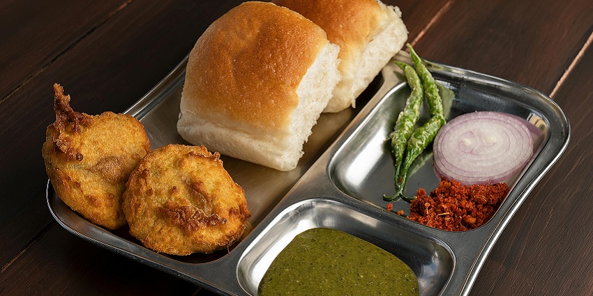 A colorful combination plate of Maharashtrian food, showcasing vibrant dishes and flavors.